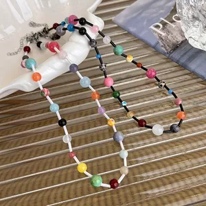 Colorful bohemian beaded crystal necklace on a luxury gold tray for a trendy summer look