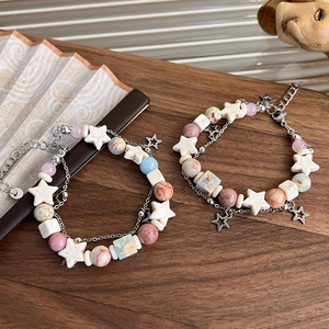 Detail of bohemian beaded bracelets with natural stones and silver star charms
