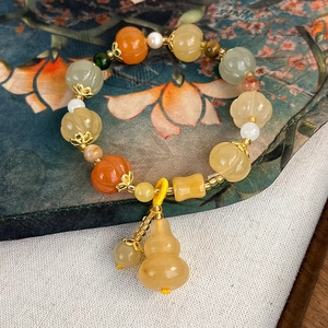 Minimalist Chinese style beaded bracelet with pumpkin beads and yellow gourd pendant