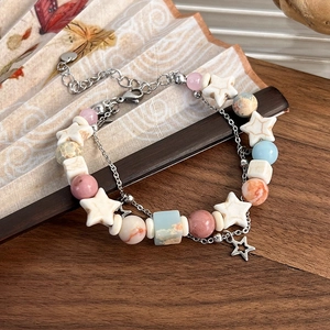 Double-layered beaded bracelet with natural pastel stones and metal star pendant
