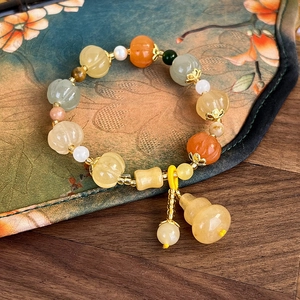 Minimalist beaded pumpkin stone bracelet with jade gourd charm in elegant Chinese style