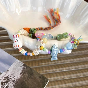 Handmade beaded bracelet with ceramic rabbit carrot charms and colorful tassels