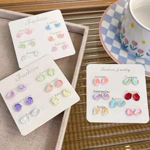 Colorful resin butterfly and heart earring set with weekly labels on a display card