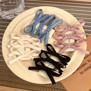 Close-up of elegant French lace ribbon bow hair clips in multiple pastel colors