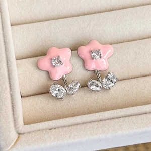 Detail of pink floral earrings with enamel petals and sparkling cubic zirconia center