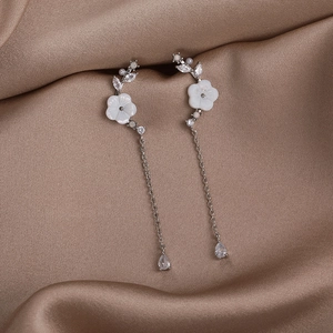 Detail of shell flower earrings with 925 silver needles and hanging zircon drops
