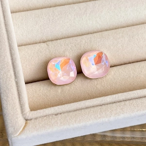 Macro shot of sweet pink crystal stud earrings with gold base on a velvet jewelry tray