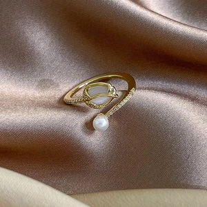 Detailed close-up of tulip pearl open ring featuring sparkling micro-pave zircons and gold plating