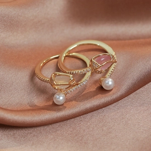 Macro detail of adjustable tulip pearl rings with pink stones and pavé zircon accents