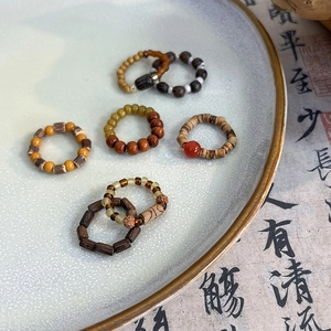 Handmade Neo-Chinese vintage beaded rings with wood and agate stones on ceramic plate