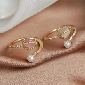 Macro detail of tulip pearl open ring with rose crystals and sparkling pavé diamonds