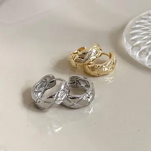 Quilted metal hoop earrings in gold and silver finishes with elegant textured patterns