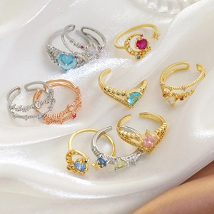 Flat lay of luxury adjustable rings with heart and star designs on white silk