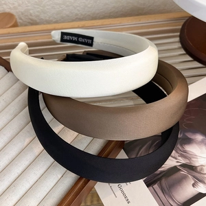 Three-piece satin headband set in cream, brown, and black with handmade inner label