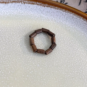Detailed view of handmade neo-Chinese wooden bead ring with dark brown textured beads