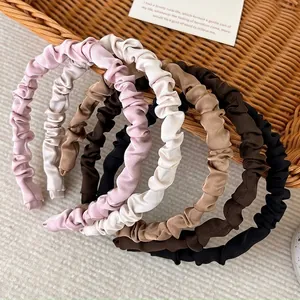 Set of five pleated satin headbands in earth tones featuring a stylish ruched design