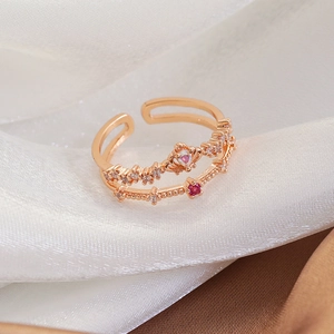 Macro shot of rose gold double-layer open ring featuring heart-shaped stones and zircons