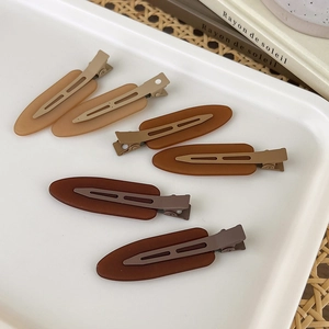 6-piece set of matte brown resin duckbill hair clips for styling in a minimalist tray