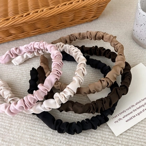Elegant satin pleated headband set in earthy tones for a high-volume hair look