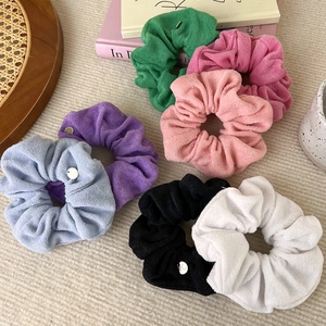 Set of colorful velvet towel fabric scrunchies with metal charms in premium aesthetic