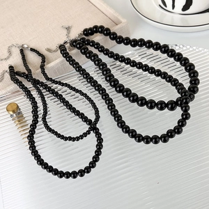 Minimalist black glass bead necklace set with metallic clasp and adjustable chain