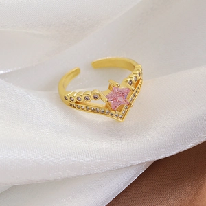 Close-up of pink star-shaped gemstone on a delicate bow-style open ring for women