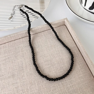Close-up of black beaded necklace with S925 sterling silver clasp and adjustable chain