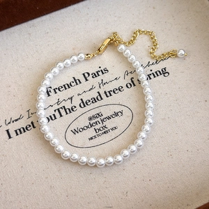 Close-up of elegant pearl bracelet with gold lobster clasp and adjustable extension chain