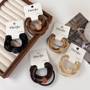 Set of minimalist elastic hair bands in neutral earthy tones with matte bead accents