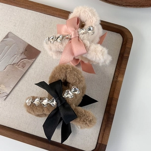 Elegant plush bow hair claw clips with heart-shaped rhinestones for stylish women