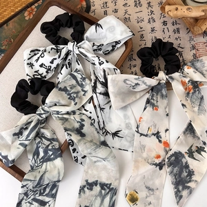 Detail of ribbon hair scrunchie with ink wash style calligraphy and bamboo patterns