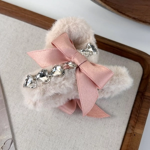 Detailed view of pink plush hair claw clip with satin bow and heart crystal rhinestones