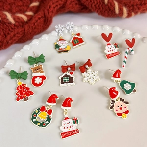 Christmas earrings set featuring Santa, reindeer and tree in a ceramic pearl dish