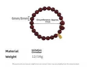 Detail view of deep red beaded bracelet featuring lotus seed pod and golden Fu pendant