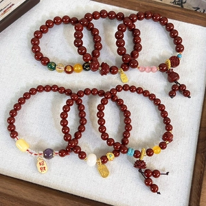 Vintage red beaded bracelet with gold lotus pendants and auspicious character charms