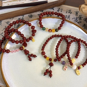 Retro Chinese cinnabar beaded bracelet with lotus charm and lucky character pendant