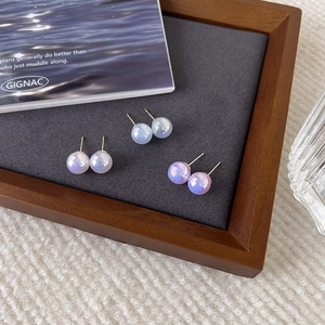 Three pairs of elegant iridescent pearl stud earrings in pink blue and purple tones