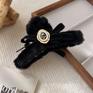 Detail of plush hair claw clip with black velvet bow, vintage flower and pearls
