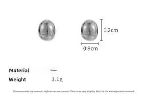 Detailed view of silver oval stud earrings in copper with 1.2cm height and 3.1g weight