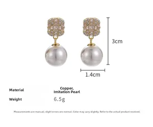 Detailed view of zircon and pearl drop earrings with dimensions 3cm x 1.4cm and 6.5g weight