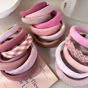 Detailed shot of pink padded sponge headbands with velvet, knit and pearl textures