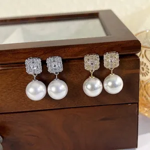 Elegant gold and silver cubic zirconia stud earrings with large round white pearls