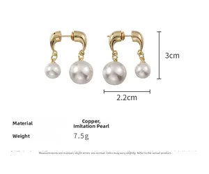 Detailed view of French vintage gold hoop earrings with large and small pearls