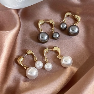 French vintage double pearl stud earrings with gold U-shaped metal on champagne silk