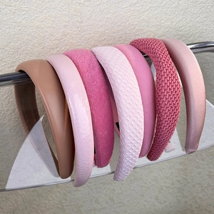 Detail showing a variety of pink padded headbands in various fabrics and textures
