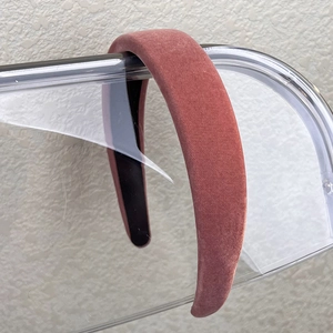 Detail of wide dusty rose velvet headband showing soft fabric texture and inner lining