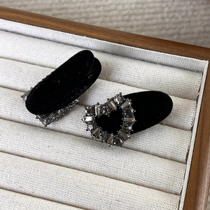 Close-up of velvet hair clips with grey rhinestone heart in a premium jewelry display box
