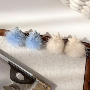 Winter plush star stud earrings in blue and cream with soft faux fur pompon details