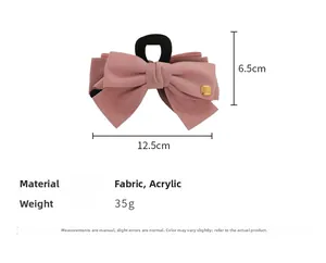 Detail view of mauve fabric bow hair clip showing size dimensions and golden brand name tag