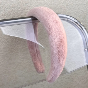 Close-up of the soft pink plush texture and thick padded sponge of this fashion headband